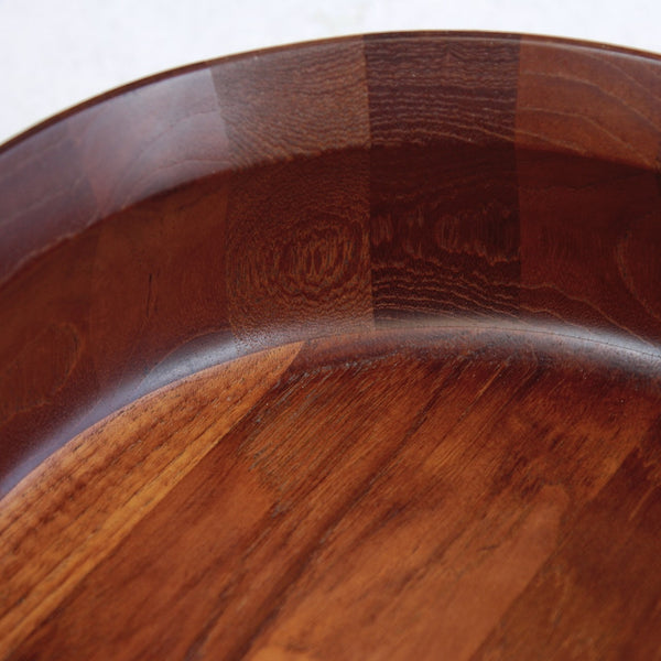 Close up of staved sections on a 1960s Danish teak fruit bowl by Jens Quistgaard. A stunning Dansk Designs object blending simplicity, utility, and sculptural form.