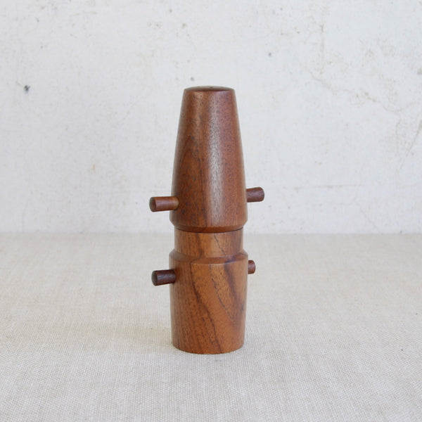 Wooden pepper grinder on a light background. Early Jens Quistgaard peppermill by Dansk Designs, highly desirable mid-century modern collectible.
