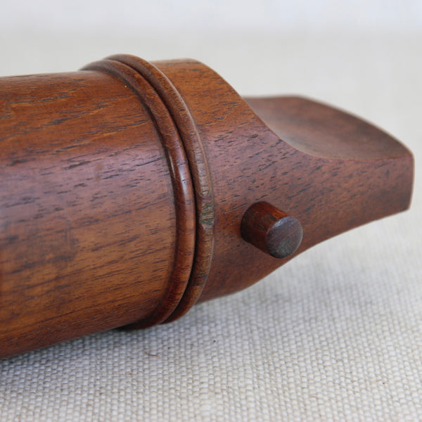 A vintage Scandinavian “mouthpiece” pepper mill in solid teak, designed by Jens Quistgaard for Dansk Designs and prized by collectors.