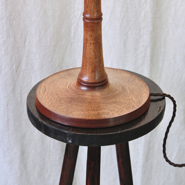Close view of the dark grained ash on an Esben Klint table lamp, with two incised collars recalling the natural nodes of bamboo.
