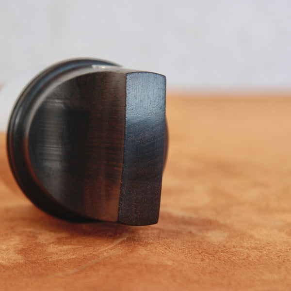 Vintage rosewood pepper mill by Jens Quistgaard for Dansk Designs, image showing the end grain of the richly coloured natural timber.