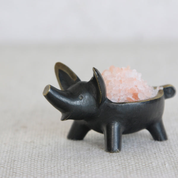 Mid-century Austrian brass pig salt cellar by Walter Bosse, made by Herta Baller, combining playful design with meticulous craftsmanship.