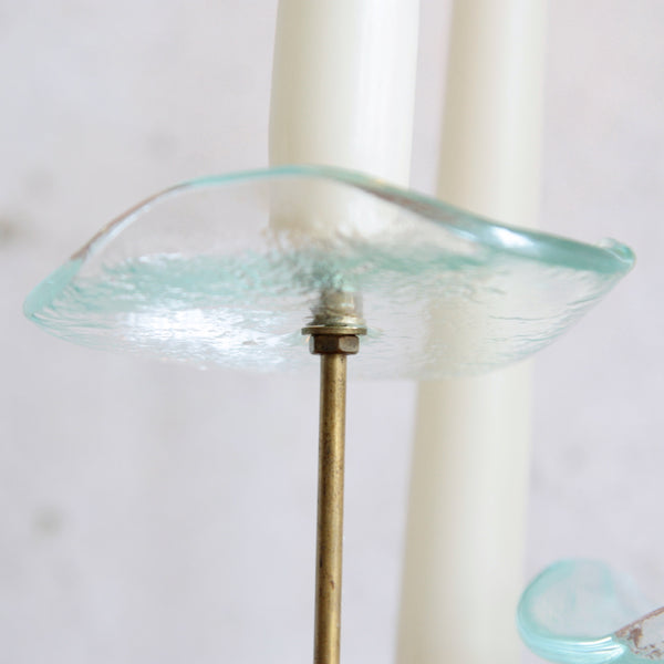 Vintage Scandinavian flower candlestick in golden brass with green-tinted glass drip pans.
