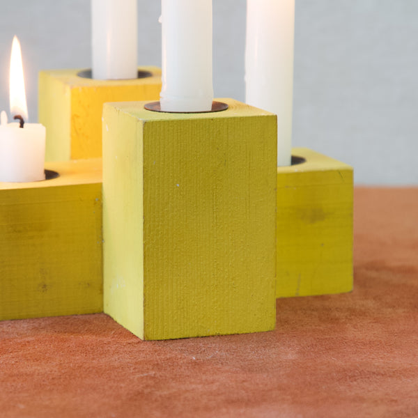 Detail of yellow painted candle holder designed by Erik Höglund