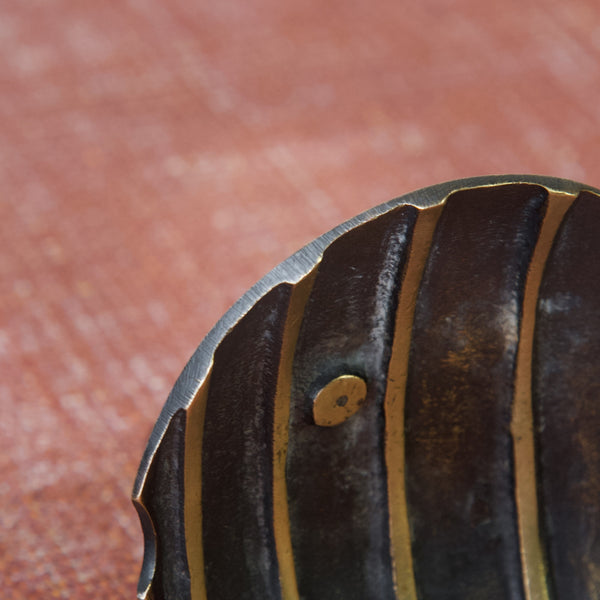 Close up showing the filed edge of a fish shaped dish or ash tray designed by leading 20th Century metalware designer Walter Bosse for Herta Baller, Austria.