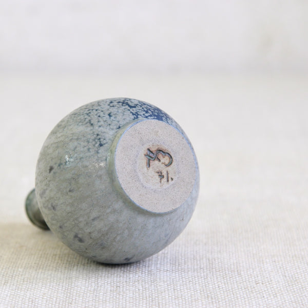 Underside / base of a handmade stoneware vase by Arne Bang featuring Bang's AB monogram and the model number 71. Hand inscribed and glazed signature /makers mark.