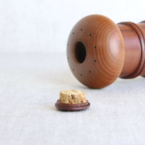 Wooden pepper grinder and salt shaker with a cork stopper. Mid-century Scandinavian pepper grinder in teak by Jens Quistgaard for Dansk Designs.