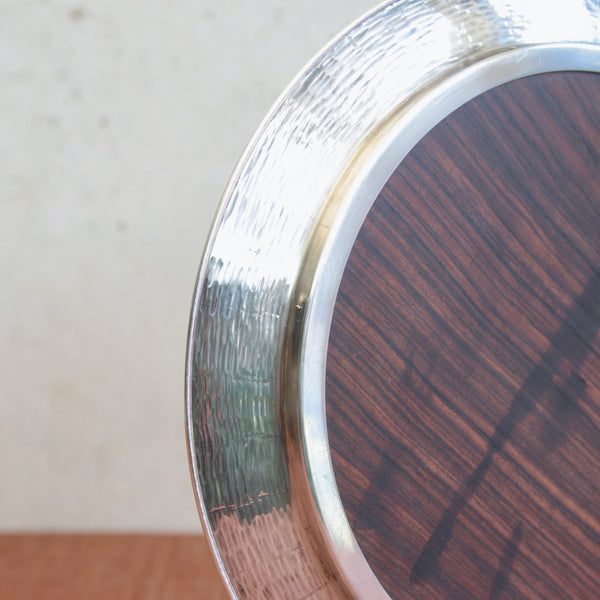 Detail of high-end Finnish design tray by Tapio Wirkkala with sculptural silver rim and ebony centre