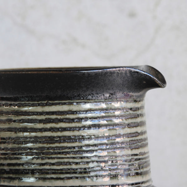 Detail shot of fine ceramic spout. Karin Björquist Modernist stoneware jug from the Gustavsberg studio, Sweden, showcasing hand-thrown craftsmanship and naturalistic texture.