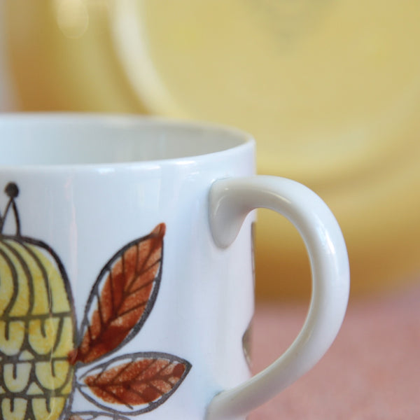 Close up of handle on a beautiful Scandinavian modern porcelain cup and saucer featuring Marianne Westman’s King design for Rörstrand — charming, scarce, and highly sought after.