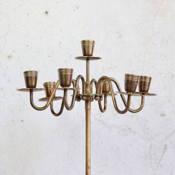 Head on shot of the top part of a vintage Scandinavian brass candelabra, seven-headed mid-century Swedish design, elegant and understated.