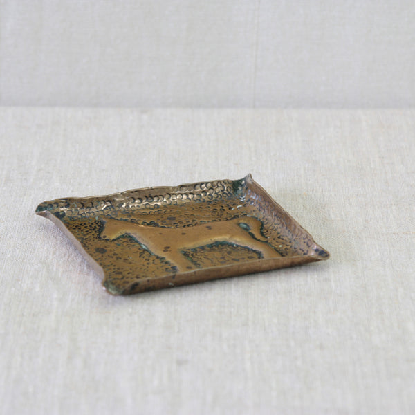 1950s English handmade brass tray, with a richly hammered surface and simple stylised horse worked into the centre.