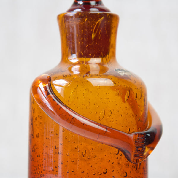 Detail of handmade quality of Erik Höglund amber bubbly glass 'People' decanter 