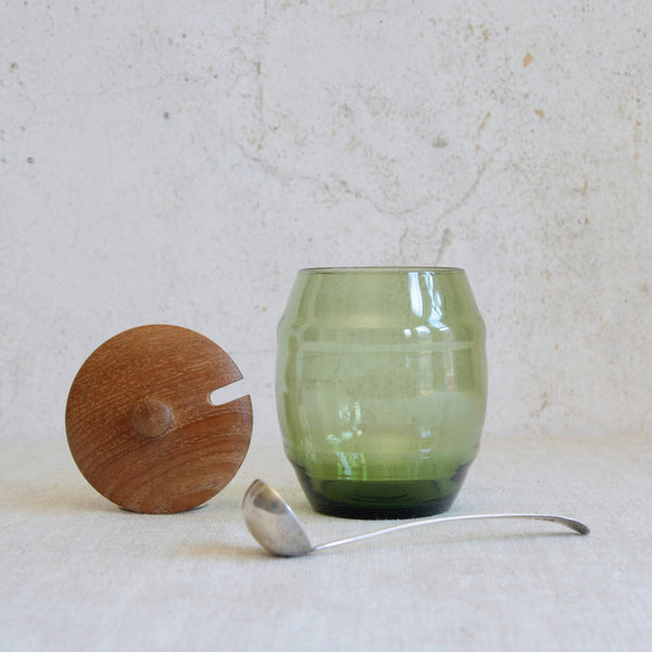 Head on shot of a vintage Swedish glass and wood storage jar designed by Erik Höglund for Boda, circa 1960, reflecting the early collaboration between Boda glassworks and Boda Trä.