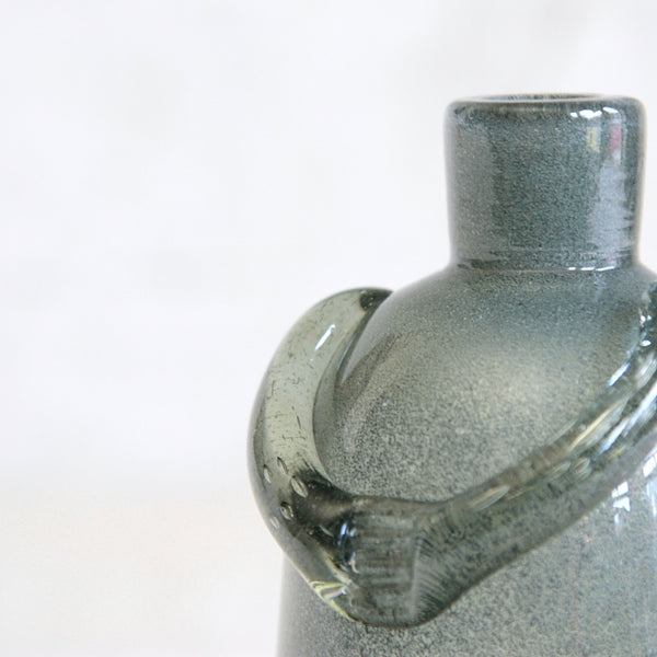 Erik Höglund Carborundum glass bottle with applied arms, an early prototype related to his later bubble-glass people decanters.