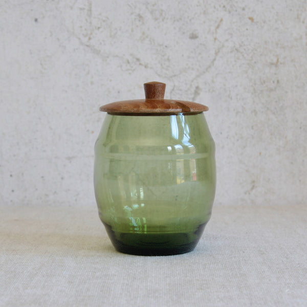 Barrel-shaped storage jar by Erik Höglund for Boda, made from solid pine and hand-blown green glass, a classic example of Swedish Modern design. For sale in the UK.