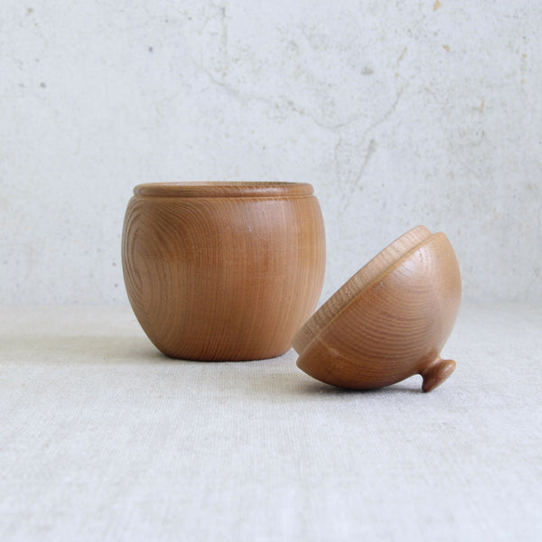 Artistic shot showing lid removed from a Boda Tra pine acorn box designed by Erik Höglund, demonstrating Swedish craftsmanship and organic modernist aesthetics.