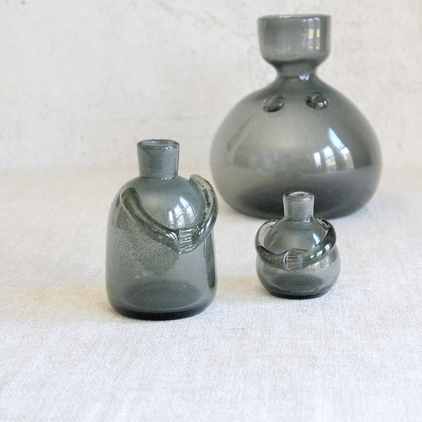 Early carborundum bottle vases in human forms designed by Erik Höglund and produced by Boda, Sweden, early 1950s, an important precursor to his celebrated people decanters.