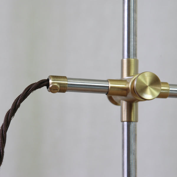 Close-up of a brass clamp on an Esben Klint Model 319 table lamp, the articulated arm can extended into a long horizontal composition.