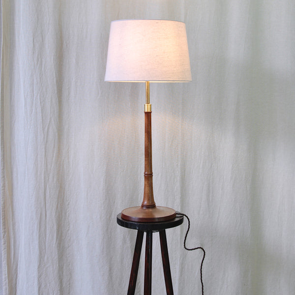 Vintage Le Klint table light by Esben Klint, with a sculptural turned ash base, slender stem and stepped brass lighting components.