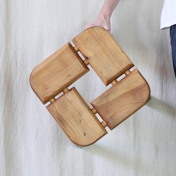 Head on view of Olof Ottelin's Finnish sauna stool, revealing the almost woven pattern created by its matching sections of solid pine.