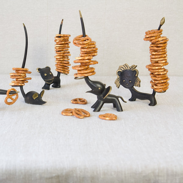 A large group of vintage Walter Bosse pretzel holders, produced by Herta Baller. The group includes Bosse mouse, elephant, dog, chipmunk and lion. 