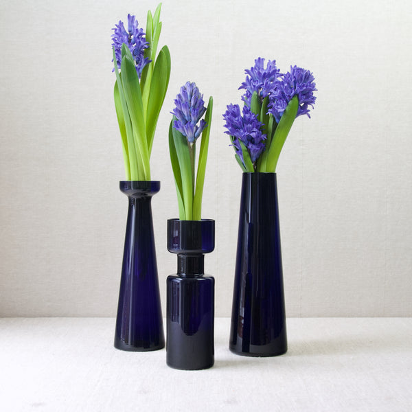 Artistic group shot of three geometric vintage glass. vases designed by Kaj Franck and Saara Hopea. One of the designs included is Model 3413 Slender Vase
