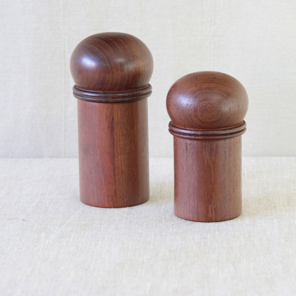 Matching mushroom-shaped salt shaker by Gunnar Cyrén for Dansk, turned from solid teak with a compact cylindrical body.
