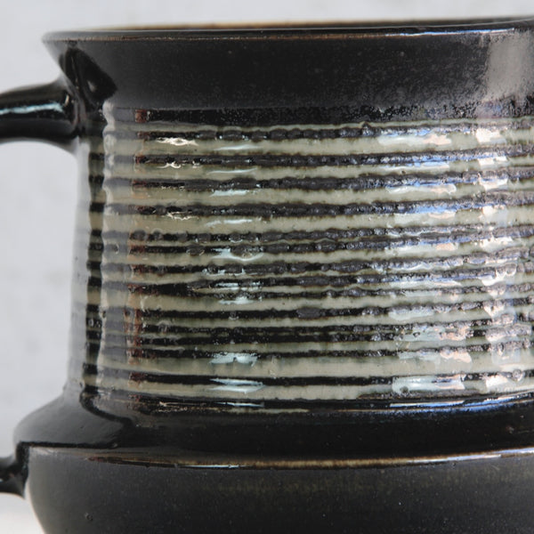 Close-up detail image. Gustavsberg studio pottery by Karin Björquist, a unique ceramic jug combining geometric structure with earth-inspired surface decoration.