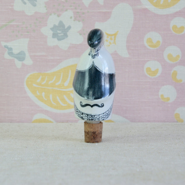 Guy Neale Cavalry Officer porcelain bottle stopper for Parkinson Pottery, with an enormous helmet and expressive hand-painted facial details.