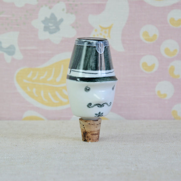 Close view of the French Gendarme bottle topper /stopper designed by Guy Neale, with a characterful moustached face hand decorated by Susan Parkinson.