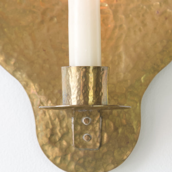 Delicately crafted brass wall sconce, perfect for adding warmth and ambiance to any space.