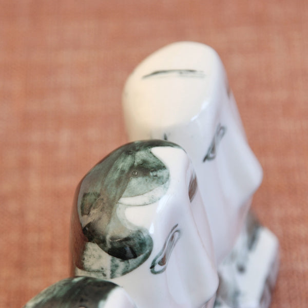 Top down view showing nicely painted hair on the men featured in 'The 8.15' by Susan Parkinson, a rare and collectible example of post-war British Modernism in porcelain.