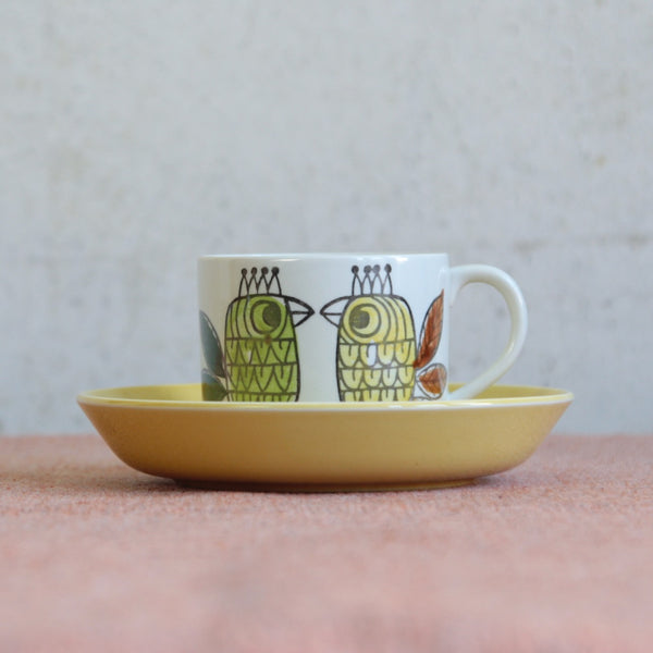 Designed by Marianne Westman for Rörstrand, this rare King pattern cup and saucer features cheerful crowned birds in bright yellow, red, and green tones.