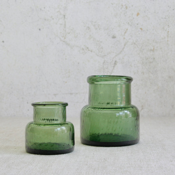 Straight on, lead image of a pair of Neptuna shouldered glass vases designed by Nanny Still for Riihimäen Lasi Oy, Finland, 1964, featuring optically moulded texture.
