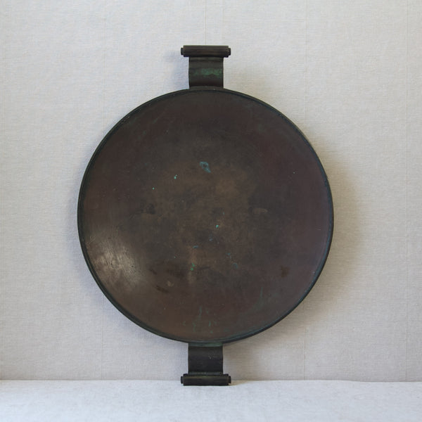 Straight on shot of a Swedish Grace bronze platter by Einar & Sune Bäckström. The 80 - 90 year old item has a beautiful patina, including verdigris.