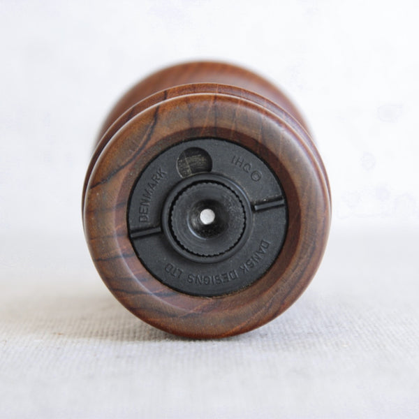 Base of collectible 1960s Dansk Designs pepper mill by Jens Quistgaard. Black plastic grinding mechanism reads ‘Dansk Designs Ltd Denmark IHQ’.