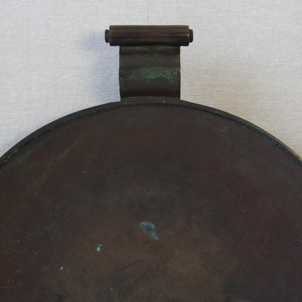 Detail of verdigris on a bronze platter with scroll handles. This Art Deco period design is in the Swedish Grace style and was created by Einar & Sune Bäckström.
