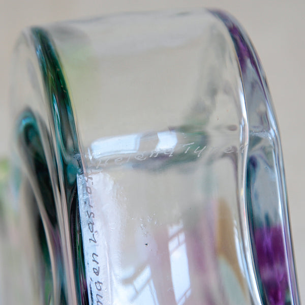 Close-up of hand-etched signature / makers mark on the base of a Riihimäen Lasi Bora Bora vase by Helena Tynell, mould-blown glass with swirling interior form and subtle iridescent colour effects.