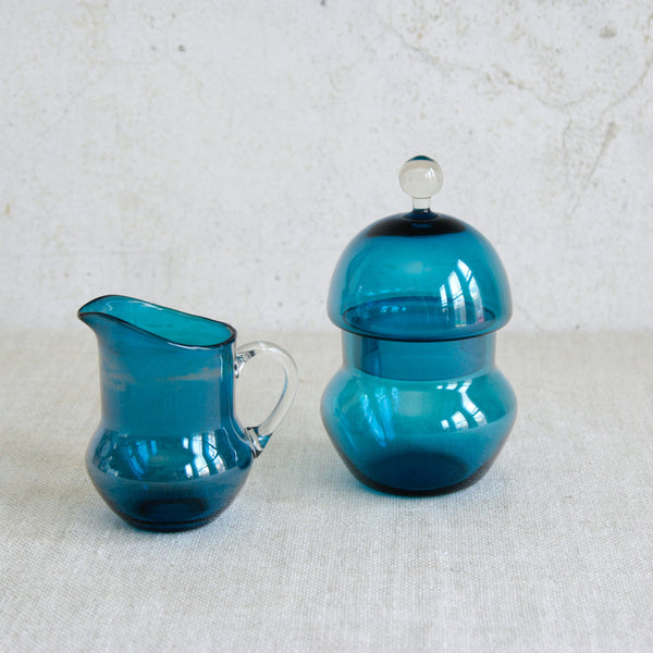 Sugar bowl and creamer from the Pomona series designed by Helena Tynell for Riihimäen Lasi Oy in Finland, 1960, in hand-blown turquoise glass