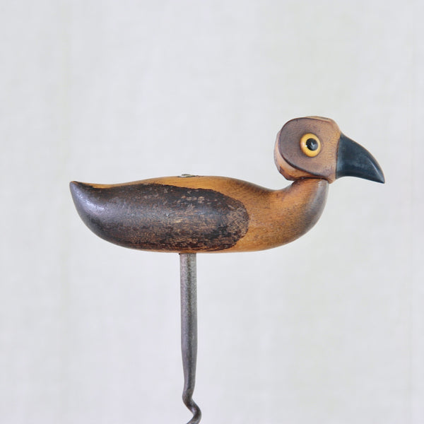 Vintage YZ bird corkscrew from 1925, with carved wood body, rattan head, navy Bakelite beak and steel corkscrew.