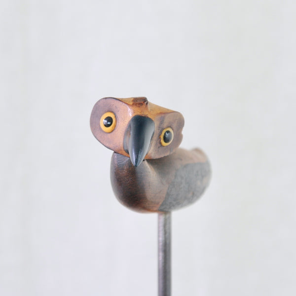 Close-up of the glass eyes and beak on the head of a YZ bird corkscrew dating from 1925.