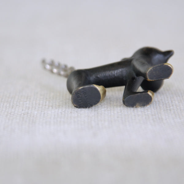 Underside of a charming brass monkey corkscrew by Walter Bosse; iconic 1950s Herta Baller production combining playful sculpture with functional vintage barware design. Foot of monkey stamped with makers mark 'BALLER', and country of origin, 'AUSTRIA'.