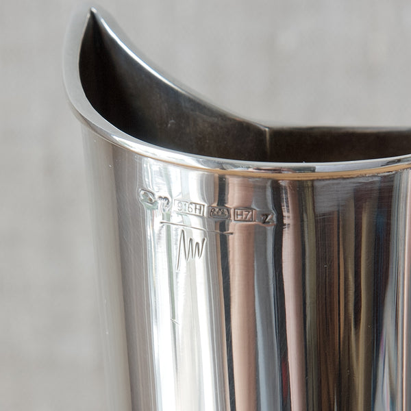 Close up showing a full set of Finnish hallmarks on a Tapio Wirkkala solid silver vase. The manufacturer is Kultakeskus Oy. The date mark H7 if dor 1961.