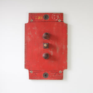 Industrial wooden mould for machine part, painted bright red, wall hung