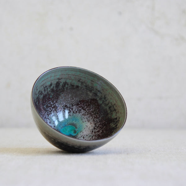 Rare 1972 Berndt Friberg porcelain bowl laying on its side, the photos shows the interior of the bowl which features a complex dappled glaze; prized Scandinavian modern ceramic art.