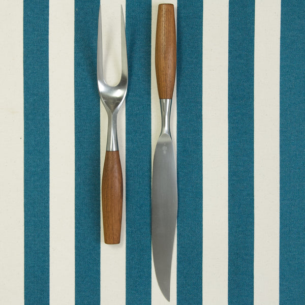 A carving knife and carving fork from Jens Quistgaard's 'Fjord' silverware service designed in MidCentury Denmark. This set is a first production example and was made in Germany by Dansk Designs.