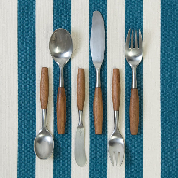Image showing one of each of the six different pieces of flatware in this six person set. The dinner forks, knives and spoons are arranged top and tail. The design, called 'Fjord', is by Jens Quistgaard.