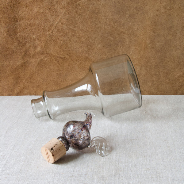 A model KF 502 1502 Kukkopullo rooster bird bottle by Kaj Franck. The image shows the stopper and bottle separated. The materials include glass and cork. The techniques involved include freeform hand blown glass and mould blown. This item is a museum quality example of mid twentieth century Scandinavian glass from Finland.