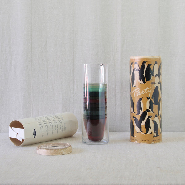 Complete 1950s Kaj Franck Party-set beside its wonderfully graphic original cylindrical packaging decorated with black and white penguins.